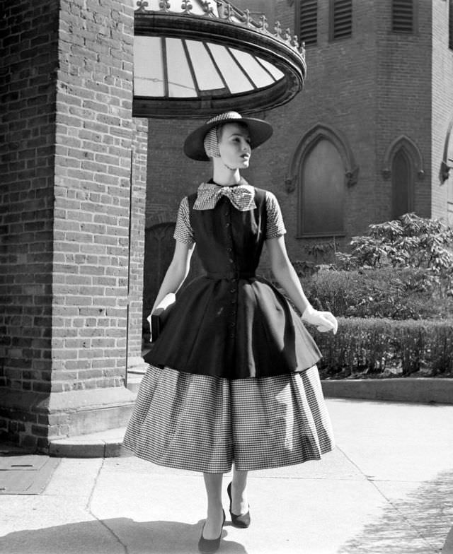 #32 Lillian Marcuson is wearing a two-part dress suitable for town by Traina-Norell with a two-part hat by Emme, 1955