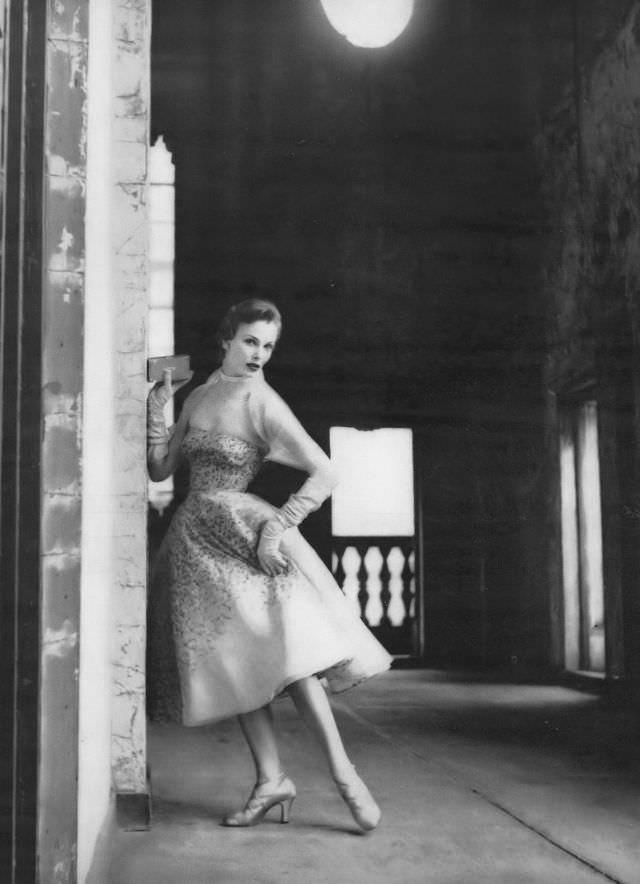 #6 Lillian Marcuson in strapless dress of champagne-colored organdy, embroiderd all over in tones of beige with a sheer organdy jacket by Sheila Lynn, Vogue, June 1950