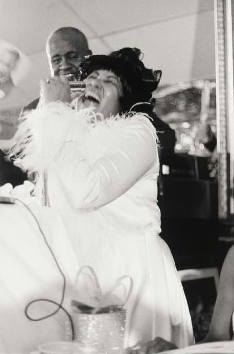 #11 Made by Ernest C. Withers. Photograph of Aretha Franklin in a white jacket with feathery cuffs, sings into a microphone – Smithsonian