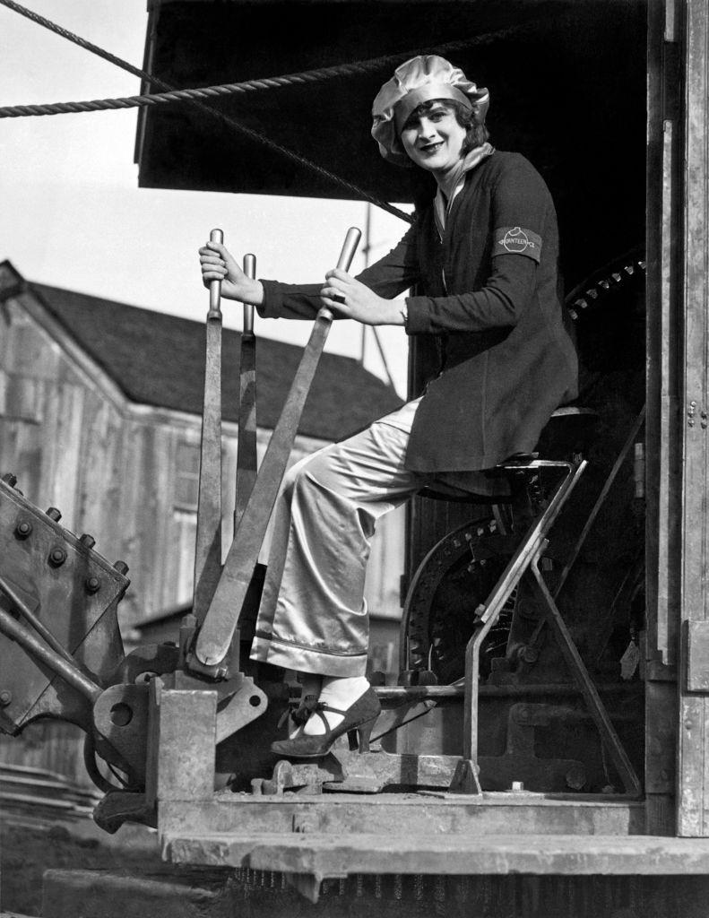 #12 A smiling woman at the controls of a steam shovel, Oakland, 1930.