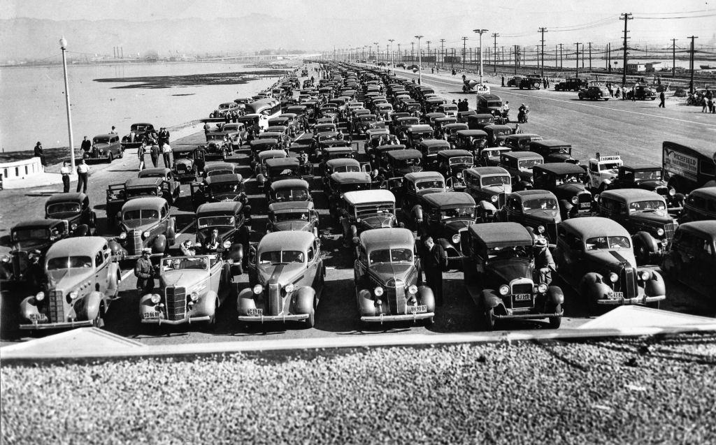 #3 Cars line up at the toll plaza as far as the eye can see to be the first to cross the new bridge, Oakland, 1936.
