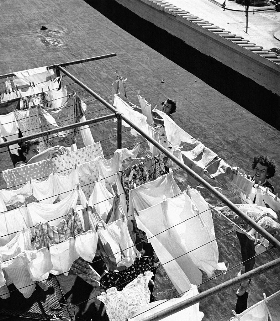 #23 Young women hanging out their laundry on the roof of the YWCA (Young Woman Christian Association) ‘Blue Triangle Club’ in Oakland, 1940s.
