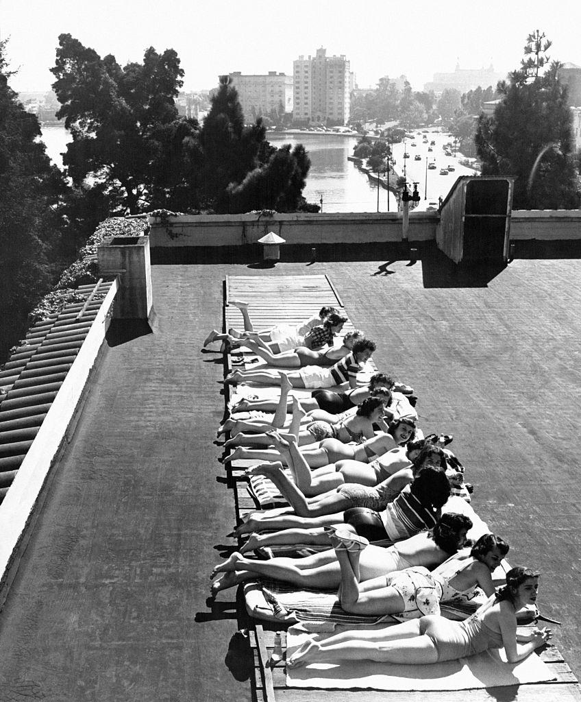 #10 Young women sunbathing on the roof of the YWCA (Young Woman Christian Association) ‘Blue Triangle Club’ in Oakland, 1940s.