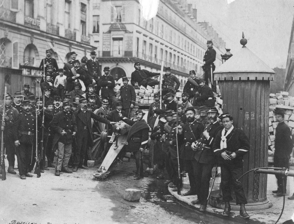 #22 National guardsmen pose in front of an artillery barricade in the Place Vendome, following the Franco-Prussian War.