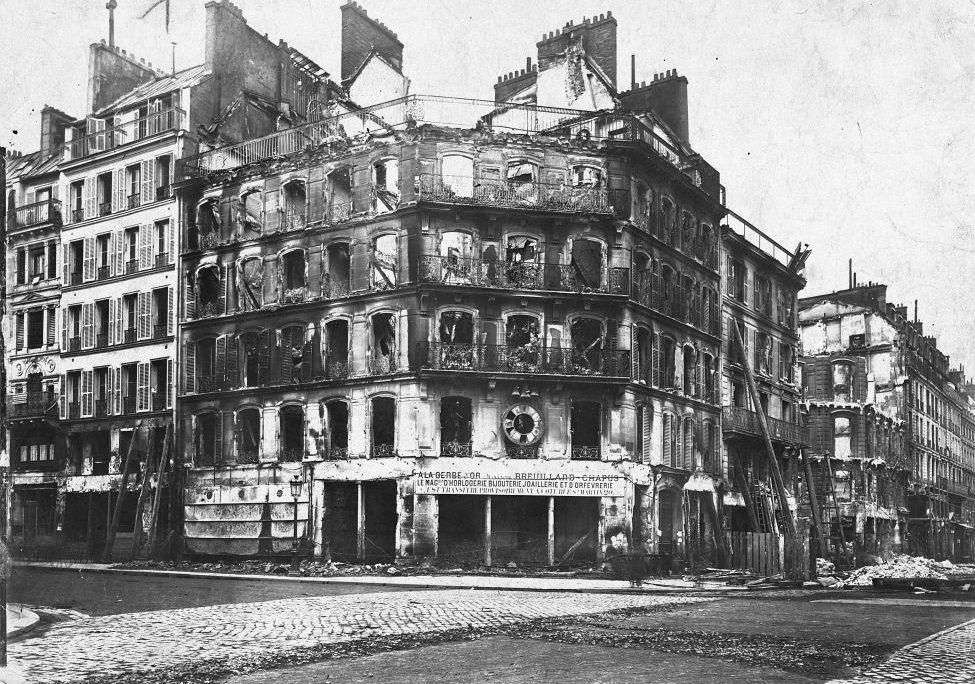 #17 A corner building in Paris shows burn damage inflicted by Prussian occupation troops after the surrender of France in the Franco-Prussian War.