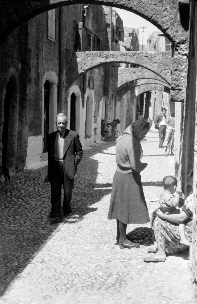 #56 People in a small alley on Rhodes, Greece, 1950s.