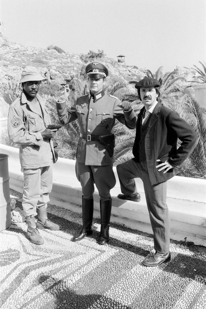 #75 Richard Roundtree, Roger Moore and Sonny Bono on the set of ‘Escape to Athena’ in Rhodes, Greece, 8th March 1978.