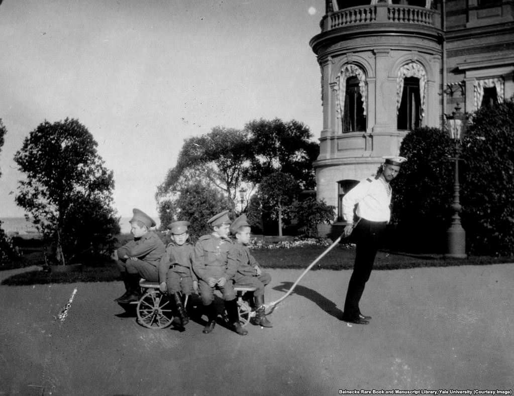 #26 Klementy Nagorny (right) was also tasked with looking after Tsarevich Aleksei (second from right on trolley).