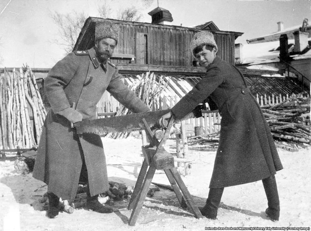 #31 Tsar Nicholas II and his son Aleksei sawing wood while in captivity. They were killed a few months later.