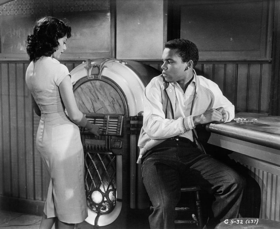 #3 Ruby Dee with Johnny Nash at the juke box in a scene from the film ‘Take A Giant Step’, 1959.