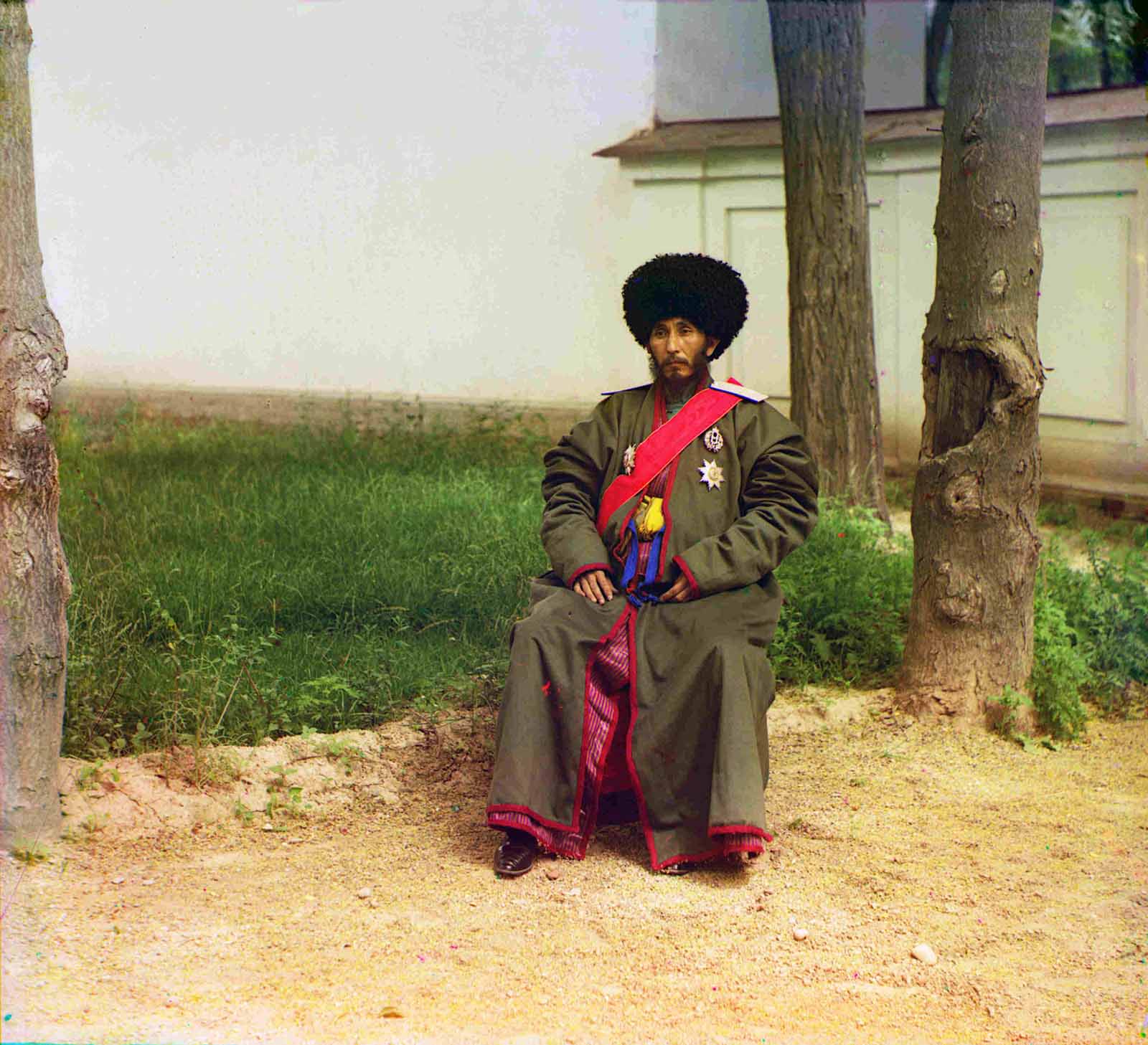#104 Isfandiyar Jurji Bahadur, Khan of the Russian protectorate of Khorezm (Khiva, now a part of modern Uzbekistan), full-length portrait, seated outdoors, 1910.