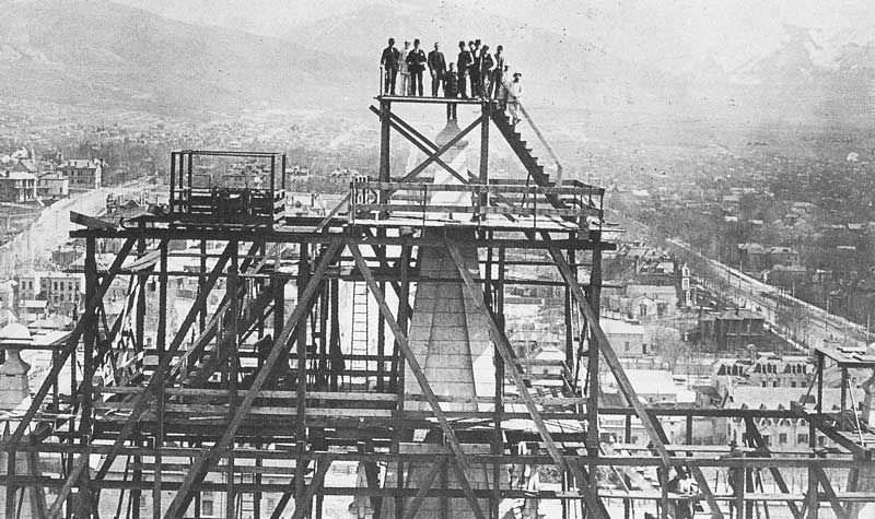 #54 Situated on the opposite tower, Carter photographed temple workers standing on the pinnacle where the capstone was to be lowered into place.