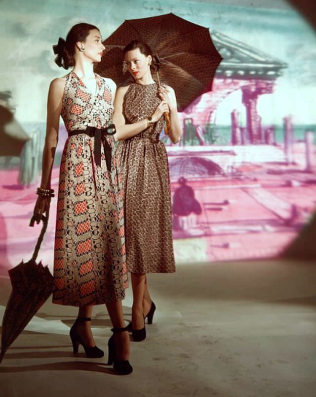 #24 Dorian Leigh and Meg Mundy in print dresses by Traina-Norell, background painted by Eugene Berman, Vogue, March 15, 1947