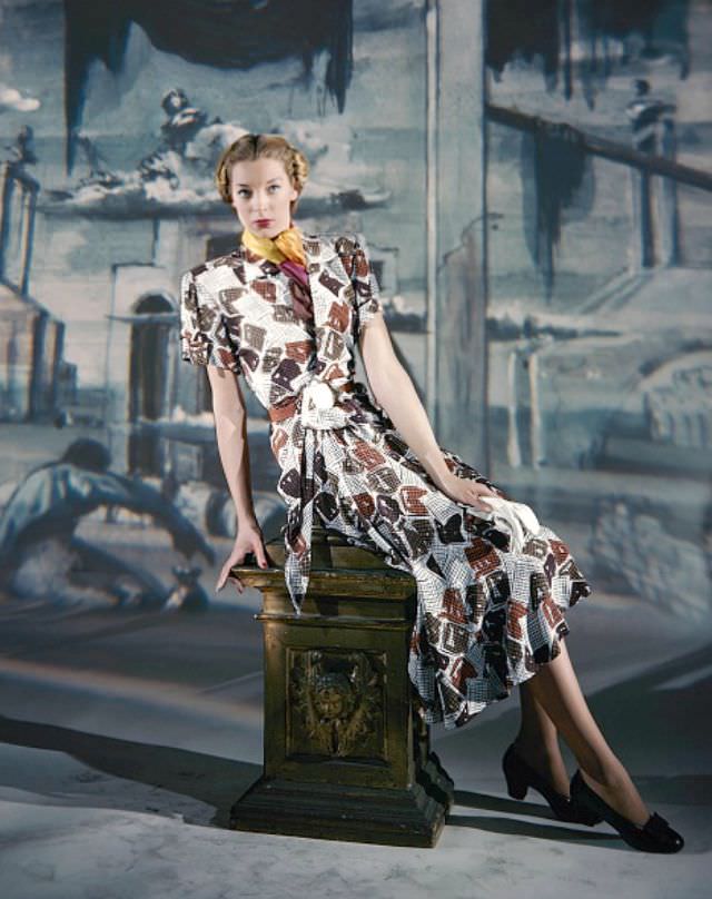 #28 Model wearing short-sleeved print dress by Joseph Halpert, background painted by Eugene Berman, Vogue, March 15, 1947