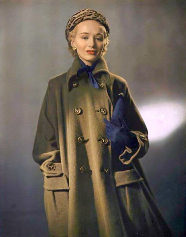 #29 Ford model Sandra Nelson in wool-alpaca coat by Originala paired with winter navy accessories and ocelot hat, 1948