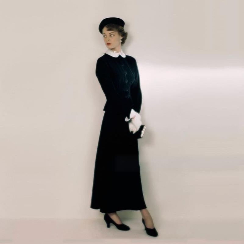 #30 Jean Patchett in a black velvet theatre suit with white collar and cuffs worn with matching beret, October 1948