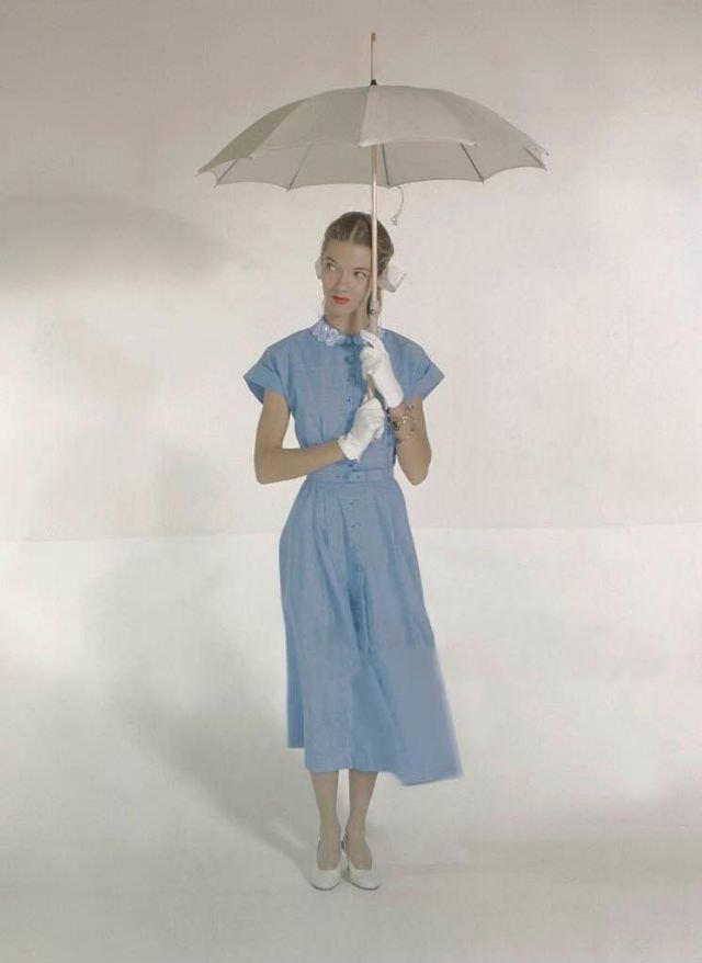 #34 Model wearing dress with embroidered collar and cuffed sleeves by Nelly Don, gloves by Meyers, dyed linen shoes by Mademoiselle, and parasol by Town Umbrella Co., Glamour, 1948