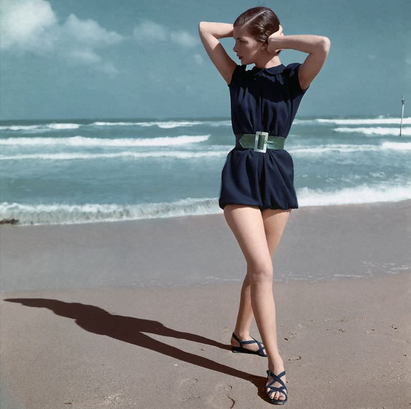 #4 Model is wearing fisherman blue beach-suit with green belt by Carolyn Schnurer, 1945