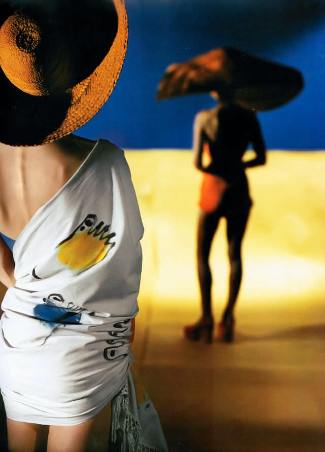#5 Model is wearing knotted-fringe beach stole of unbleached printed muslin by June Groff, Vogue, January 1945