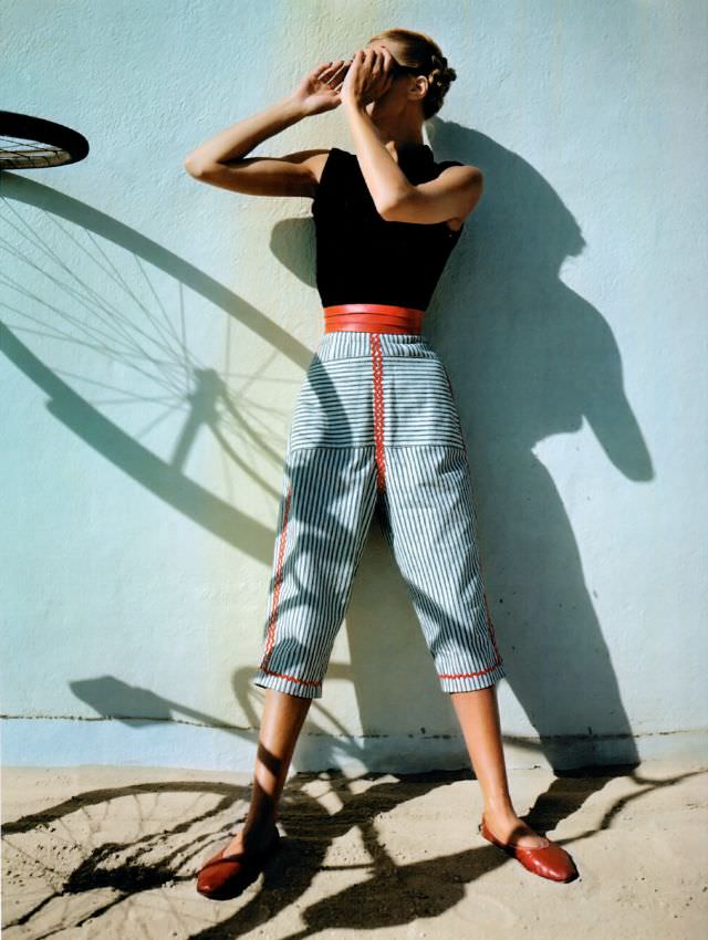 #6 Model is wearing mattress ticking capri pants with red trim together with sleeveless turtleneck from Hi-Dee, Vogue, April 1945