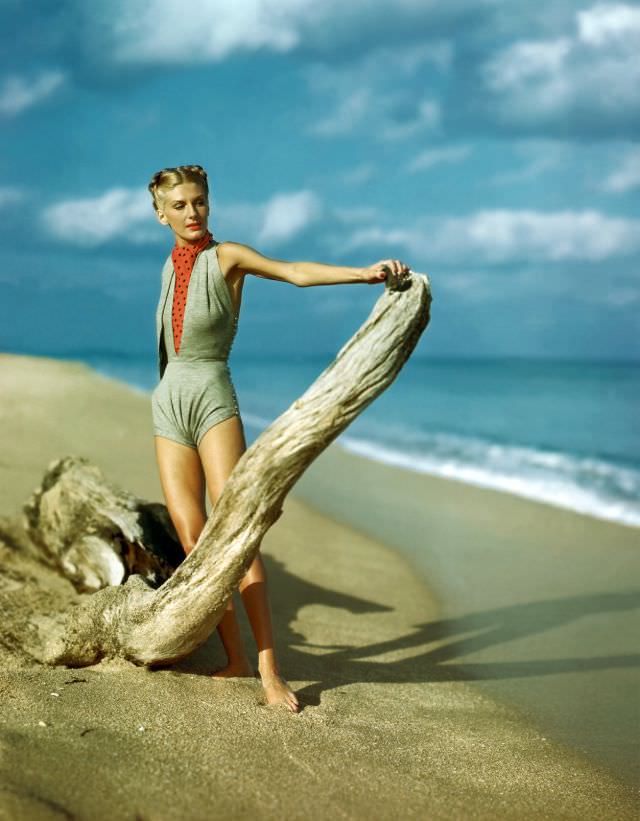 #7 Model wearing gray V-midriff swim suit with polka-dot ascot, by Claire McCardell, 1945