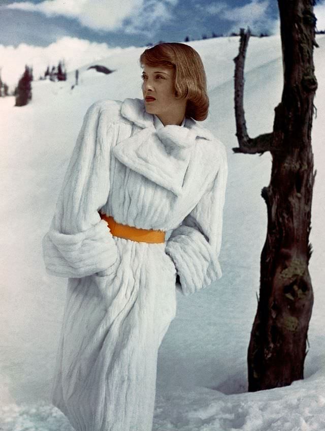 #9 Charlotte Payne wearing white trench coat of Russian ermine from Reine, 1946