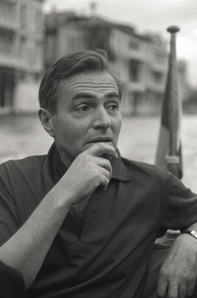 #133 The actor James Mason having a conversation on boat, in the course of the 17th Venice Intenational Film Festival.