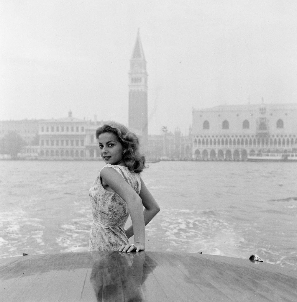 #71 Abbe Lane, American singer and actress, enjoys a motorboat ride along the Grand Canal