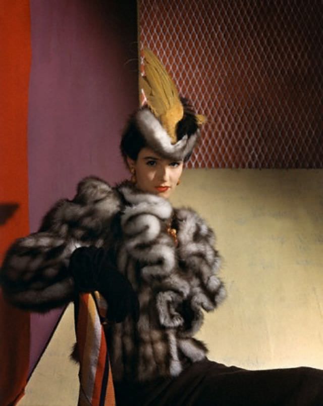 #25 Babe Paley is wearing a be-winged marten hat and jabot revers on a natural marten hat by John Frederics, 1939