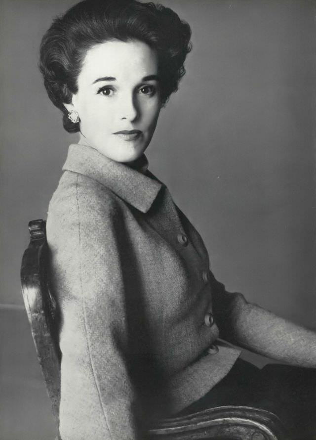#17 Babe Paley in pale blue tweed jacket over a navy-blue skirt by Mainbocher, March 15, 1954