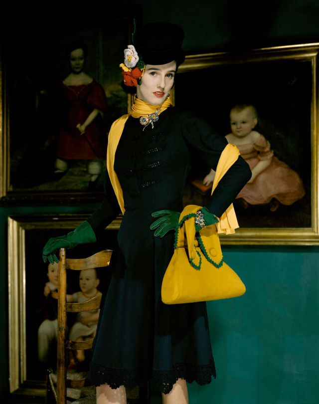 #3 Babe Paley wearing a contrasting wool suit with a yellow bag with green crochet details, 1941