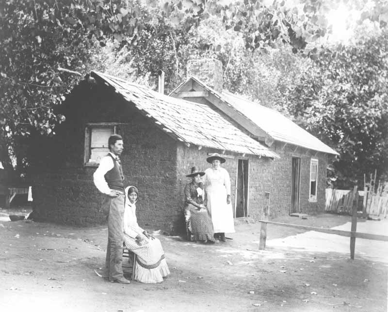 #6 A Mexican family (Juan Levis and three women) in front of a house on Rancho El Tejon, 1880s