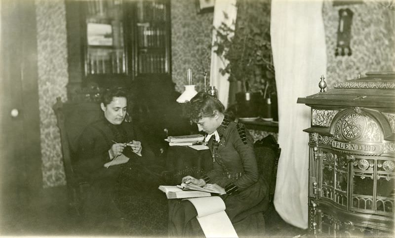 #17 Katherine Horack knits in the Horack family parlor, while Bertha Shambaugh, her daughter, appears to be copying or taking notes from a book on her lap, circa 1897-1905