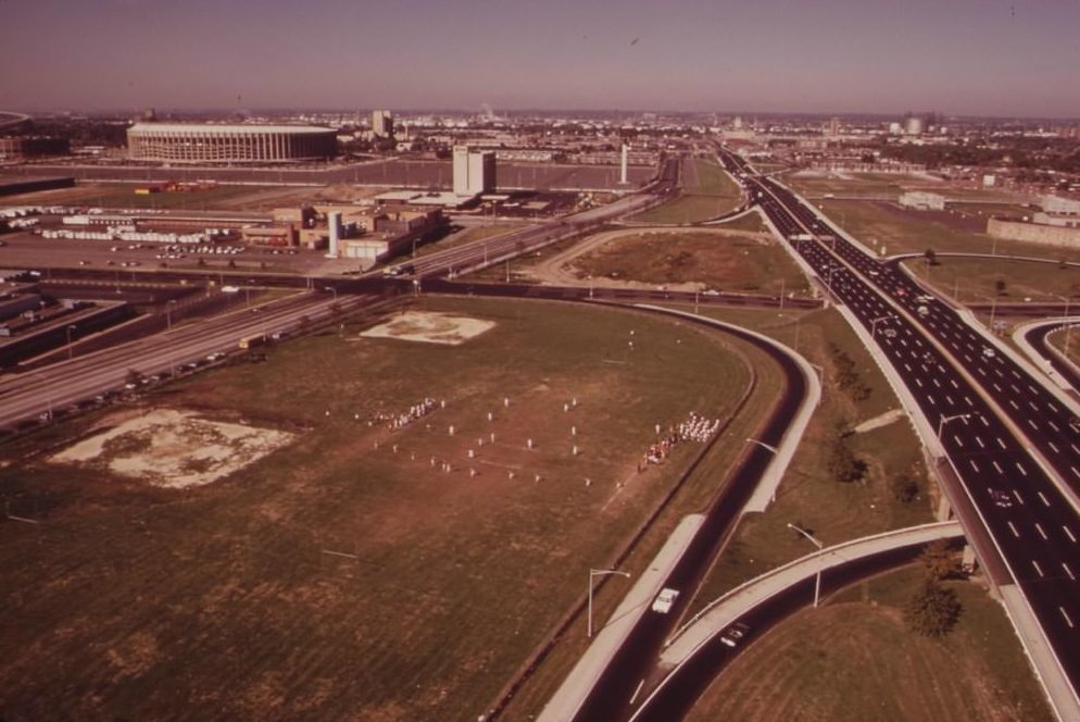 #63 Junior High School Football Team Plays On Field Surrounded By Freeways. Municipal Stadium In Left Background, August 1973