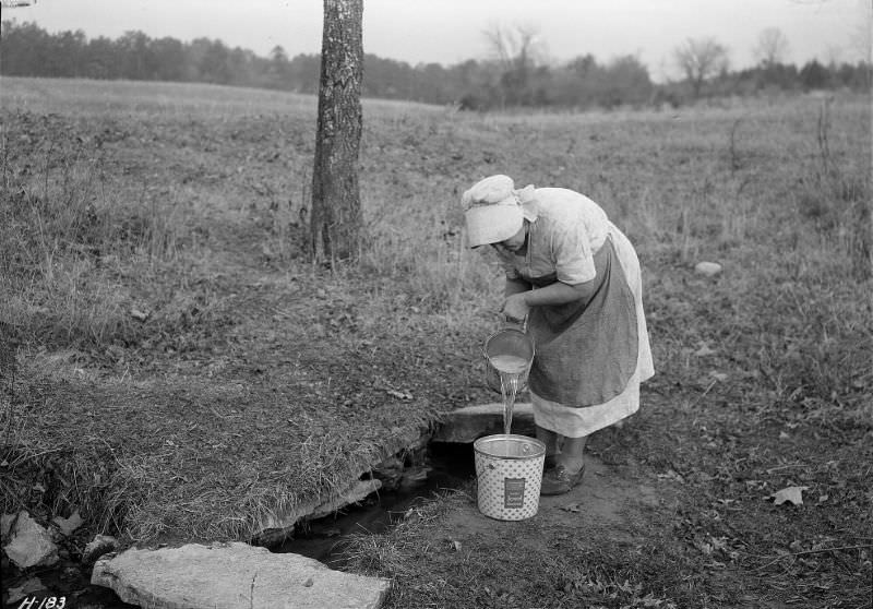 #41 Mrs. Wallace dipping water from spring on farm near Norris townsite recently purchased by the TVA for experimental purposes, Tennessee, November 1933