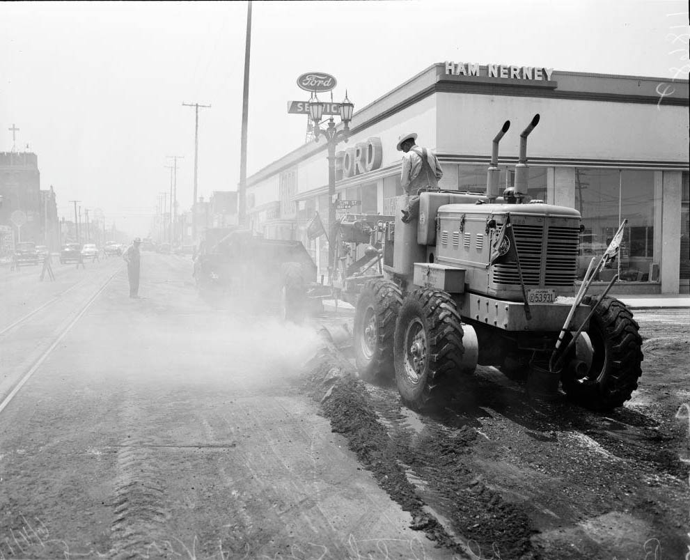 #149 Burning off black top at 52nd Street and Vermont Avenue, 1956