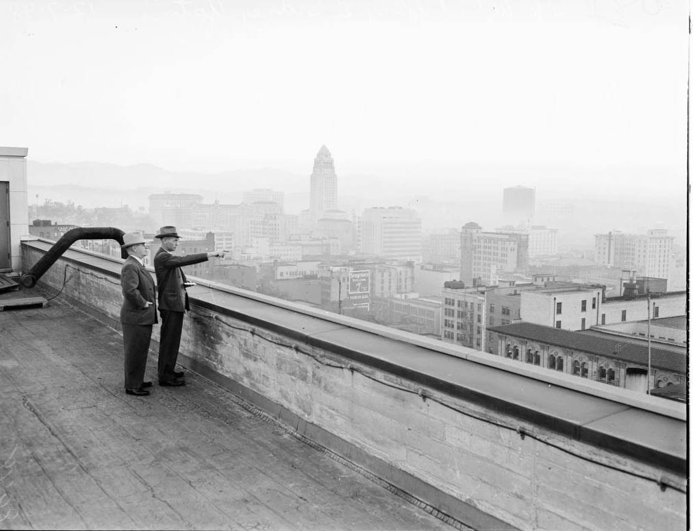 #65 Thomas A Dobbie, Junior (Air Pollution Control inspector looks over horizon for violators) and W.C Tiffany (Maintenance Foreman, Pacific Telephone & Telegraph Company), 1948