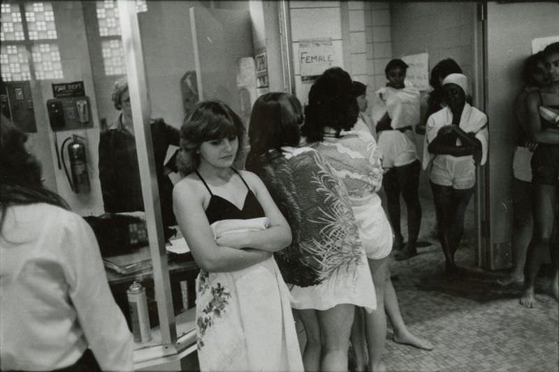 #4 Women in bathing suits wait outside a locker room