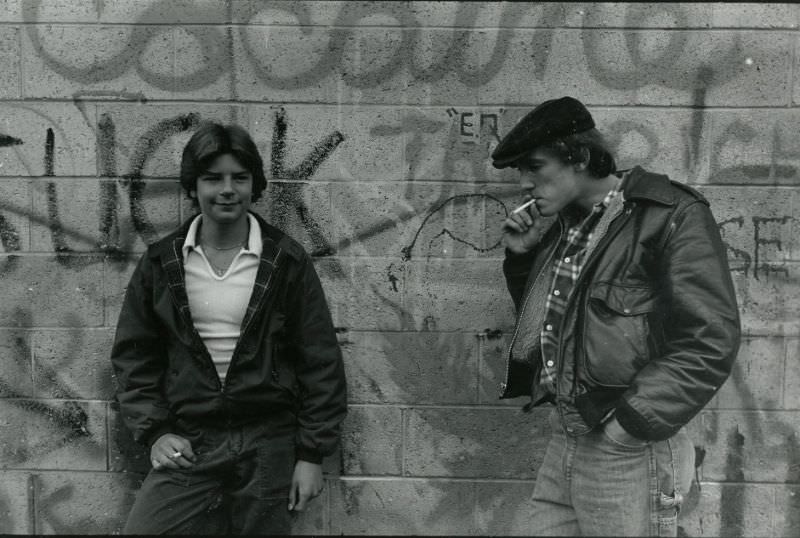 #5 Two teenagers smoking against wall