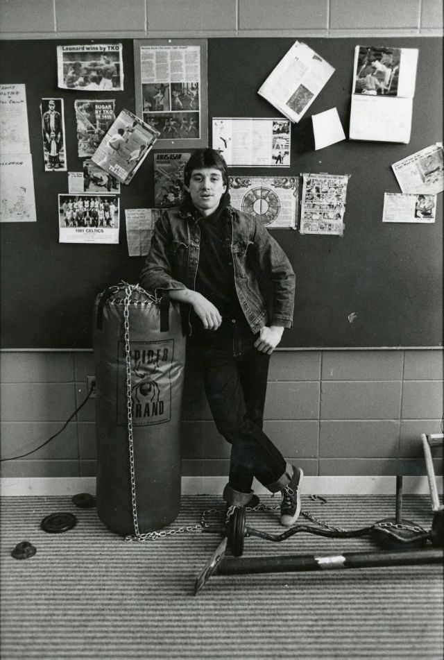 #29 Man leaning on a boxing heavy bag