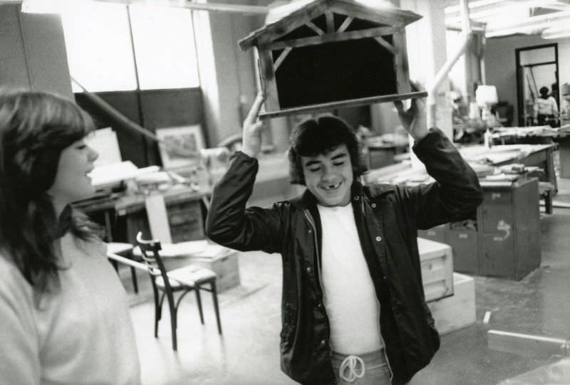 #8 Boy holding a small wooden construction above his head