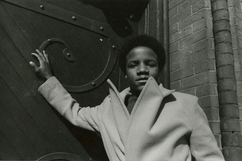 #57 Teenage boy posing in front of ornate door