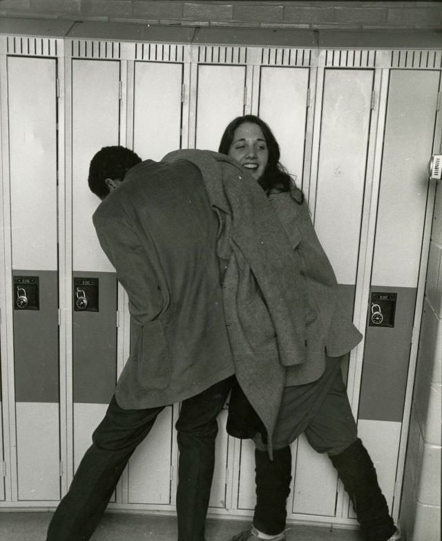 #62 Two students clowning by the hall lockers