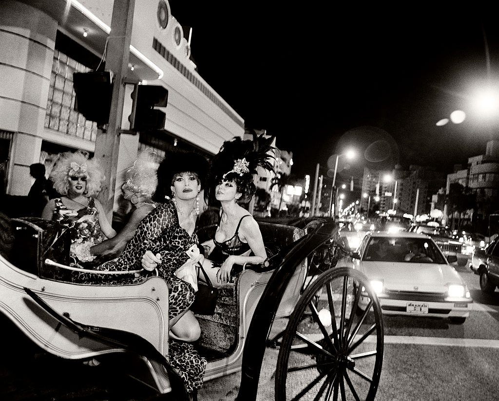 #78 Drag queens arriving in a horse drawn carriage.