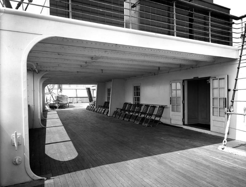 2nd Class Promenade aboard Aquitania. The starboard side of the Promenade Deck (A Deck), with a view of the sheltered area under the Boat Deck aft, May 1914