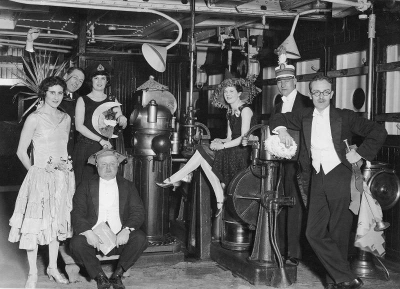 A group of Aquitania passengers pose on the liner’s bridge during a Fancy Dress Ball on the night of January 25, 1927