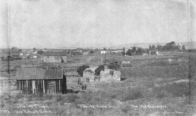 #75 View of Old Town’s adobe chapel, Don Rafael’s cabin, stone jail, and graveyard, 1895