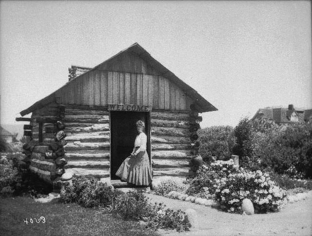 #8 Miss Littlefield standing at the entrance to a cabin in Pacific Beach, 1899