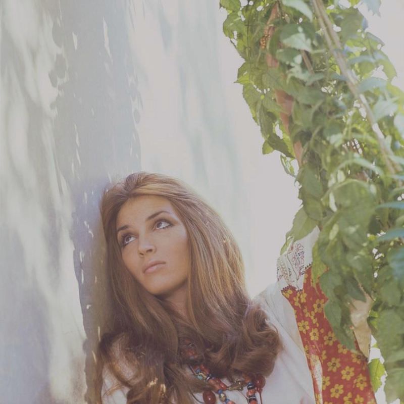 #12 Talitha Getty leaning on a wall with vines by her house in Marrakesh, Morocco, January 15, 1970