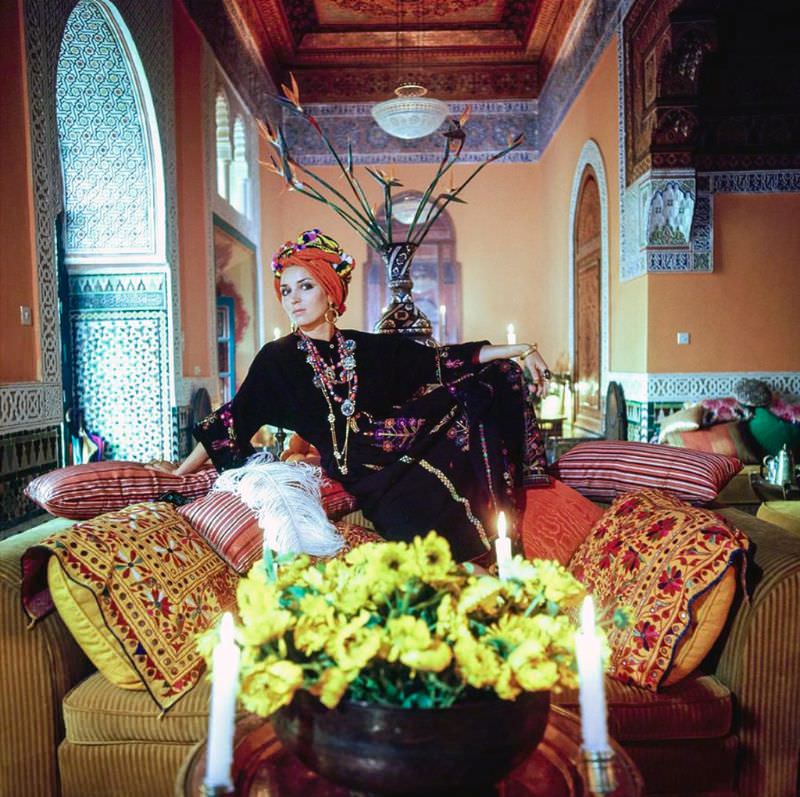 #18 Talitha Getty wearing a turban and kaftan in her living room in Marrakesh, Morocco, January 15, 1970